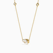 The Lab Grown Diamond Pear Station Necklace in 14K Yellow Gold features a large pear-shaped lab diamond pendant and two small round lab diamonds set along a delicate gold chain.