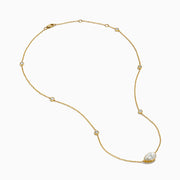 The Lab Grown Diamond Pear Station Necklace in 14K Yellow Gold features a large pear-shaped lab diamond pendant and two small round lab diamonds set along a delicate gold chain.