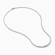 The Lab Grown Round Diamond 5.00ct Graduated Tennis Necklace in 14K White Gold features sparkling round diamonds in a slender white gold chain, displayed elegantly against a white background.