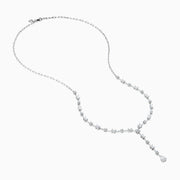 The Lab Grown Diamond Lariat Tennis Necklace in 14K White Gold showcases alternating round and rectangular lab grown diamonds, ending with a pear-shaped drop for an elegant, symmetrical look.