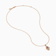 The Ruby Royale 14K Rose Gold Diamond and Ruby Hamsa Pendant features sparkling diamonds and a central ruby, showcased elegantly against a white background.