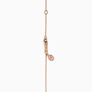 The Ruby Royale 14K Rose Gold Diamond and Ruby Hamsa Pendant features sparkling diamonds and a central ruby, showcased elegantly against a white background.
