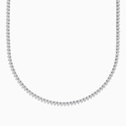 The Pave Classica 14K White Gold Diamond Tennis Necklace 6.81 TCW features evenly spaced round diamonds in a gentle curve, offering a sparkling, elegant look against a plain white background.