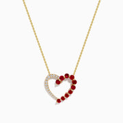 The 14K Yellow Gold Ruby and Diamond Open Heart Pendant features a chain necklace with one half adorned in sparkling diamonds and the other shimmering with vibrant red rubies.