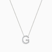 The 14K White Gold Diamond Initial G Pendant features a delicate white gold chain and a sparkling diamond-adorned G pendant, creating an elegant contrast against the plain white background.
