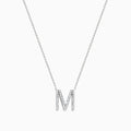 The 14K White Gold Diamond Initial M Pendant features a delicate white gold chain and a sparkling diamond-studded M pendant, displayed against a plain white background.