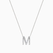 The 14K White Gold Diamond Initial M Pendant features a delicate white gold chain and a sparkling diamond-studded M pendant, displayed against a plain white background.