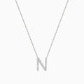 The 14K White Gold Diamond Initial N Pendant features a delicate white gold chain and a sparkling diamond-studded N, showcased on a plain white background.