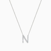 The 14K White Gold Diamond Initial N Pendant features a delicate white gold chain and a sparkling diamond-studded N, showcased on a plain white background.