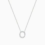 A 14K White Gold Diamond Initial O Pendant hangs delicately on a chain, featuring sparkling diamonds and displayed against a plain white background.