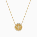 The Seaside 14K Yellow Gold White and Black Diamond Turtle Necklace features a round pendant with a turtle design outlined in sparkling white stones and an accented edge, perfect for adding everyday elegance.
