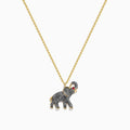 The 14K Yellow Gold Enamel Elephant Necklace features a yellow gold chain and an elephant pendant with a textured dark gray enamel body, gold accents, and a small red gemstone eye.