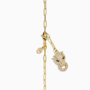 The Signature 14K Yellow Gold Diamond and Emerald Panther Necklace features a panther head pendant with diamond accents, emerald eyes, a circular ring in its mouth, an elongated link chain, and a small charm near the clasp.
