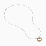 The 18K Tri-Color Gold Natural Yellow, Pink and White Diamond Circle Necklace showcases a round pendant with three rows of diamonds in pink, yellow, and white, displayed on a delicate silver chain against a white background.