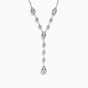 The 14K White Gold Bezel-Set Diamond Lariat Necklace showcases round and teardrop bezel-set diamonds in a Y-shaped design, all gracefully suspended from a delicate chain.