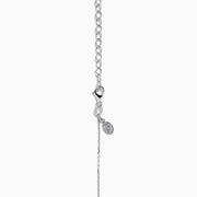 The 14K White Gold Bezel-Set Diamond Lariat Necklace showcases round and teardrop bezel-set diamonds in a Y-shaped design, all gracefully suspended from a delicate chain.
