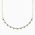The 14K Yellow Gold Emerald and Diamond Bezel Set Station Necklace features alternating round emeralds and diamonds in bezel settings, evenly spaced along the front curve of the chain, displayed on a white background.
