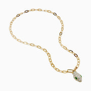 The 14K Yellow Gold White and Green Enamel Snake Paperclip Chain Necklace features a snake head pendant with white enamel scales and green accents, hanging elegantly from a sleek paperclip chain.
