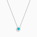 The 18K White Gold Paraiba and Diamond Pendant features a round Paraiba gemstone framed by a halo of white diamonds, elegantly suspended from a fine chain on a white background.