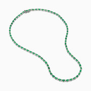 The 925 Sterling Silver Emerald and Diamond Tennis Necklace showcases a sleek row of oval green emeralds and sparkling diamonds set in sterling silver, beautifully arranged against a crisp white background.