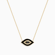 The Novelty 14K Yellow Gold Black Enamel and White Diamond Evil Eye Necklace features a pendant with a black enamel center, a bold black outline, and a ring of sparkling white diamonds.