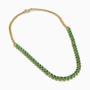 The 14K White Gold Emerald and Diamond Marquise Leaf Necklace features alternating green emeralds and white diamonds in a woven leaf pattern, elegantly displayed against a white background.