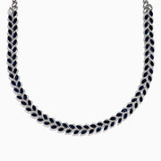 The 14K White Gold Blue Sapphire and Diamond Leaf Motif Necklace showcases a graceful, leaf-inspired design with alternating rows of blue sapphires and diamond accents for a sparkling, elegant look.