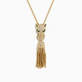The Web Exclusive 14K Yellow Gold Diamond and Emerald Lariat Tassel Panther Pendant features a diamond-encrusted panther head with emerald eyes, holding a sparkling ring and gold beaded tassels below.