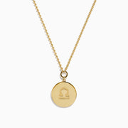 The Zodiac 14K Yellow Gold and Diamond Libra Necklace features a round pendant engraved with the scales of justice, surrounded by sparkling stones for a stunning astrological statement.