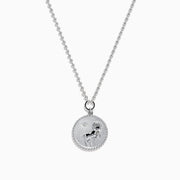 The Zodiac 925 Sterling Silver and Diamond Aries Necklace features a round sterling silver pendant with a textured edge, engraved Aries design, and hangs from a beaded chain.