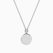 The Zodiac 925 Sterling Silver and Diamond Aries Necklace features a round sterling silver pendant with a textured edge, engraved Aries design, and hangs from a beaded chain.