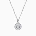 The Zodiac 925 Sterling Silver and Diamond Libra Necklace showcases a round pendant with engraved scales of justice, symbolizing Libra, suspended from a beaded chain.