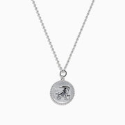 The Zodiac 925 Sterling Silver and Diamond Capricorn Necklace features a round, textured pendant engraved with a figure playing soccer, offering a unique twist on the classic Zodiac style. Shown against a plain white background.