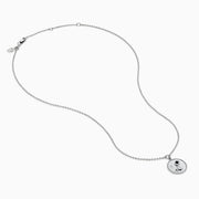 The Zodiac 925 Sterling Silver and Diamond Aquarius Necklace features a round, textured pendant engraved with a kneeling figure in prayer, offering a subtle yet meaningful tribute to the Aquarius sign.