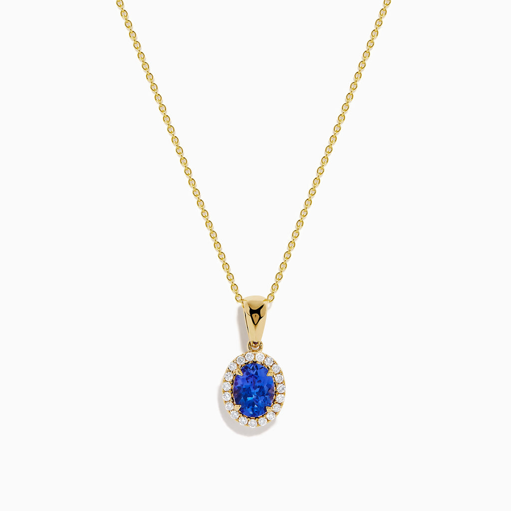 The Nahla 14K Yellow Gold Oval Tanzanite and Diamond Pendant features an oval tanzanite encircled by sparkling diamonds, displayed on a sleek yellow gold chain against a plain white background.