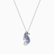 The Seaside 925 Sterling Silver Tanzanite and Diamond Seahorse Pendant features a sparkling seahorse design with tanzanite and diamond accents, hanging from a delicate chain on a white background.