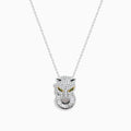 The Signature 14K White Gold Diamond and Emerald Panther Pendant features a panther head encrusted with diamond-like gems, yellow gemstone eyes, and a ring in its mouth, hanging from a delicate white gold chain.