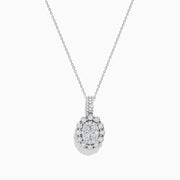 The Bouquet 14K White Gold Oval Diamond Pendant showcases an oval diamond encrusted with sparkling stones and a halo of round diamonds, elegantly displayed on a plain white background.