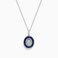 The Royal Bleu 14K White Gold Sapphire and Diamond Pendant features an oval diamond cluster surrounded by sapphires and an outer row of sparkling diamonds.