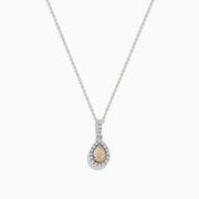 The Canare 18K Two-Tone Gold Teardrop Pendant features a yellow diamond, white diamonds, and a single clear stone above, all elegantly set and hanging from a fine chain.