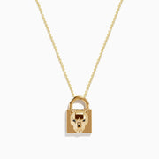 The Signature 14K Yellow Gold Black Diamond Lock Pendant features a padlock-shaped pendant with a sculpted animal face and black diamond accents, hanging from a delicate yellow gold chain on a white background.