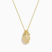 The Novelty 14K Yellow Gold Diamond Pineapple Pendant features a delicate gold chain and crisscrossed white gemstones, creating a charming accent against a white background.