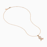 The Novelty 14K Rose Gold Pink Sapphire & Diamond Pink Ribbon Pendant features a diamond pink ribbon with clear gemstones and a single pink sapphire, displayed on a rose gold chain against a plain white background.
