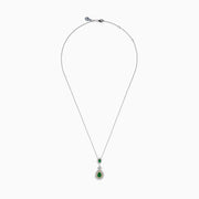 The 14K Two Tone Gold Emerald and Diamond Double Pear Drop Pendant features two pear-shaped emeralds, each encircled by white diamonds and linked with a cluster of diamonds.