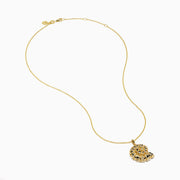 The 14K Yellow Gold Diamond Spiral Nautilus Shell Pendant features a delicate gold chain and a nautilus shell-shaped pendant adorned with sparkling diamonds and intricate detailing.