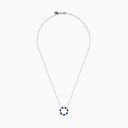 The Royale Bleu 14K white gold necklace features a circular eternity pendant with alternating blue and white sapphires, shown on a white background.