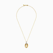 The 14K Yellow Gold Sculptural Oval Drop Pendant with Diamond Accents features an elegant oval design on a delicate chain, showcasing diamonds set in white metal at the top against a white background.