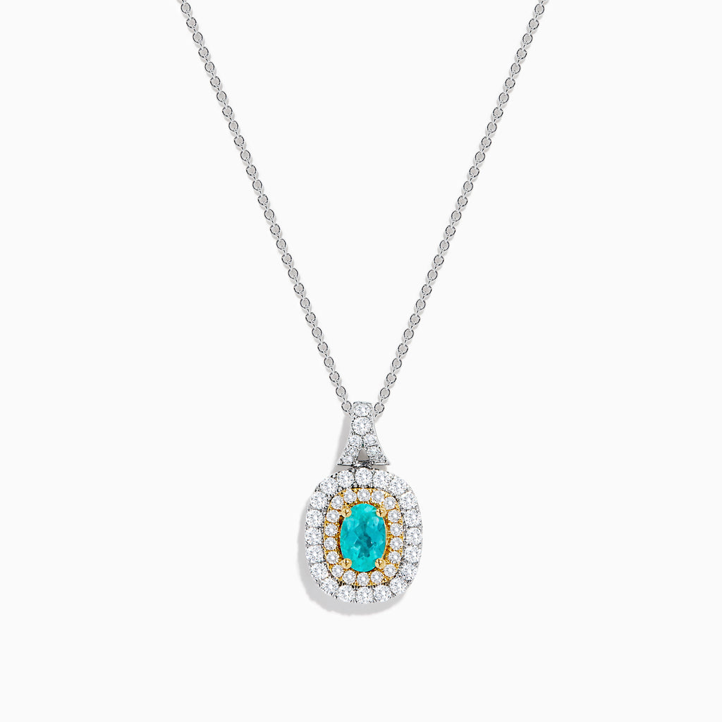 The 18K Two Tone Gold Paraiba and Diamond Double Halo Pendant showcases an oval Paraiba centerpiece, surrounded by a halo of yellow stones and a second halo of sparkling diamonds.