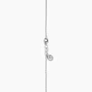 An 18K White Gold Paraiba and Diamond Pendant with an oval Paraiba gemstone and a halo of diamonds hangs from a delicate chain, shown against a plain white background.