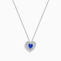 The Nahla Siri 14K White Gold Tanzanite and Diamond Heart Pendant showcases a vivid tanzanite at its center, encircled by sparkling diamonds, all set in white gold and displayed against a plain white background.